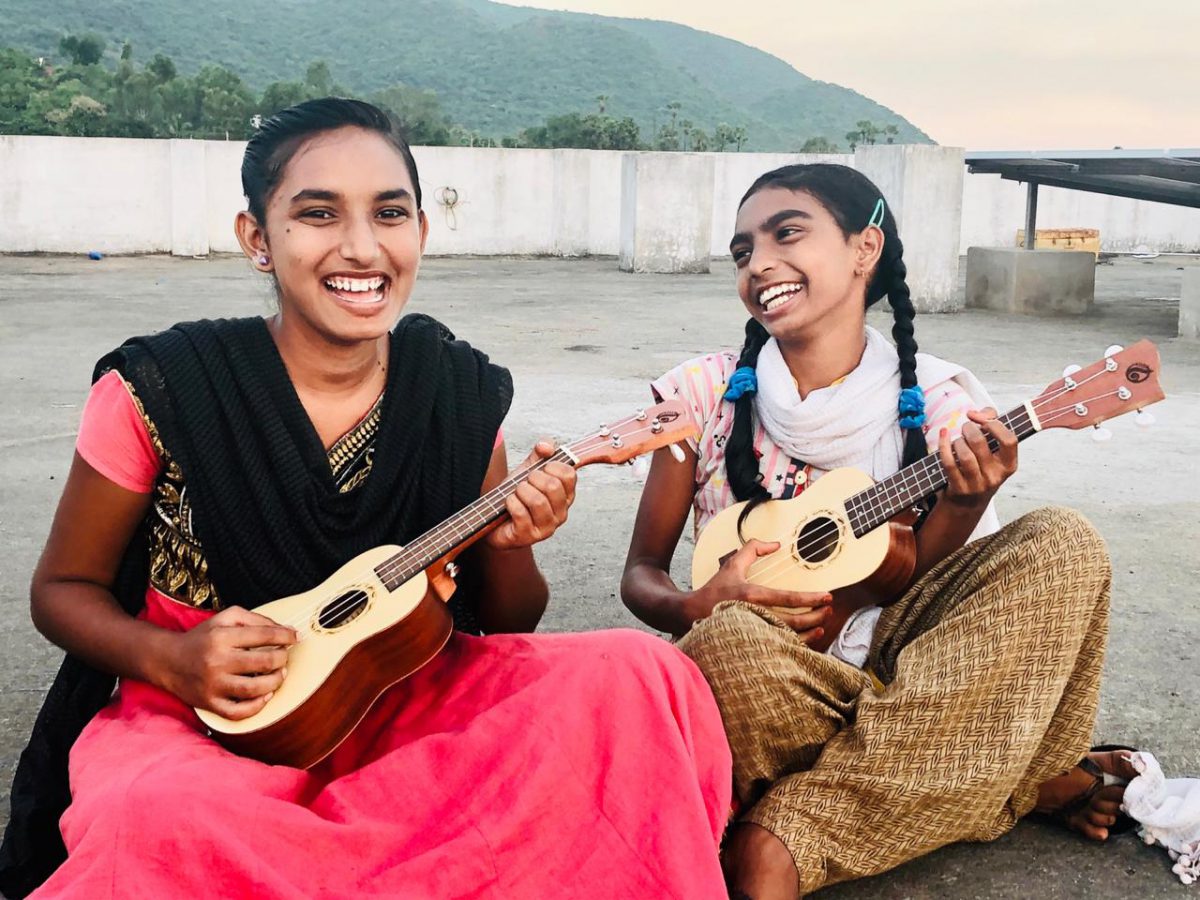 Music Students play ukuleles a Children of faith