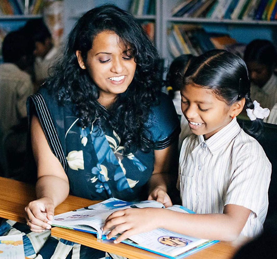 Rosie and young student reading over a workbook