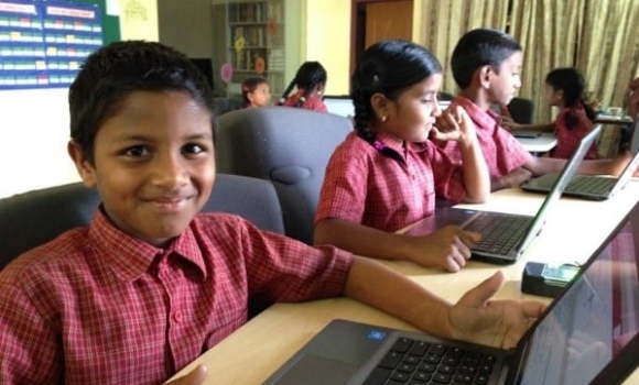 Student works at computer at Children of Faith home-school in India