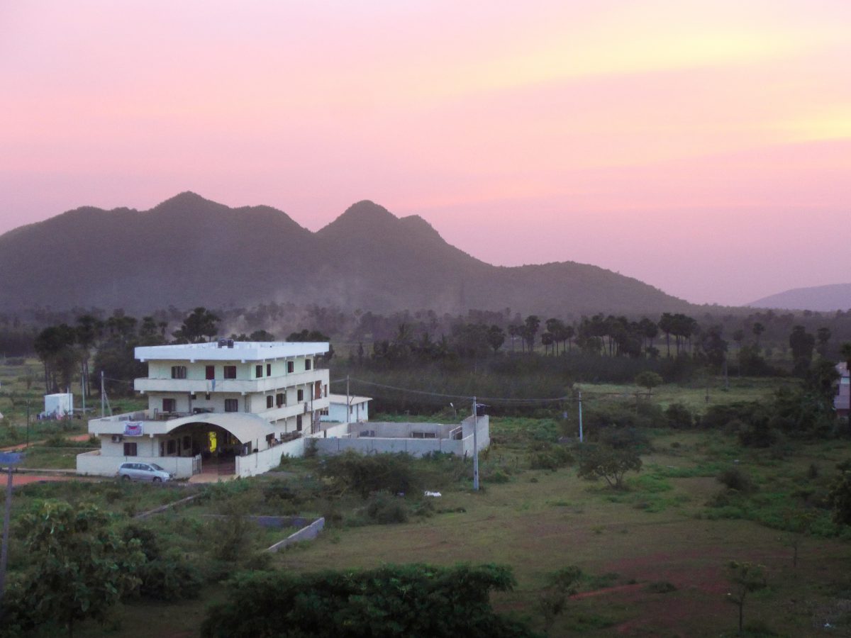 a sunset view of the main Children of Faith campus with hills in the background