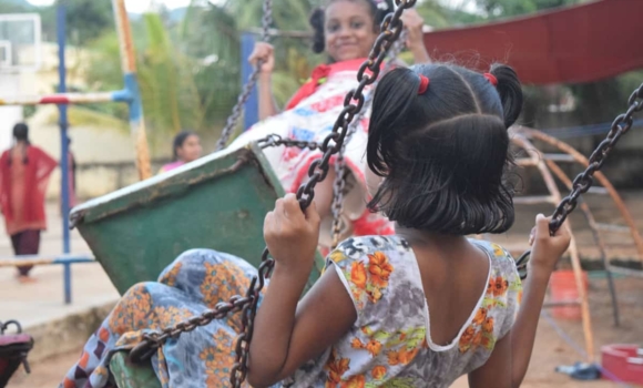 girls playing on swings