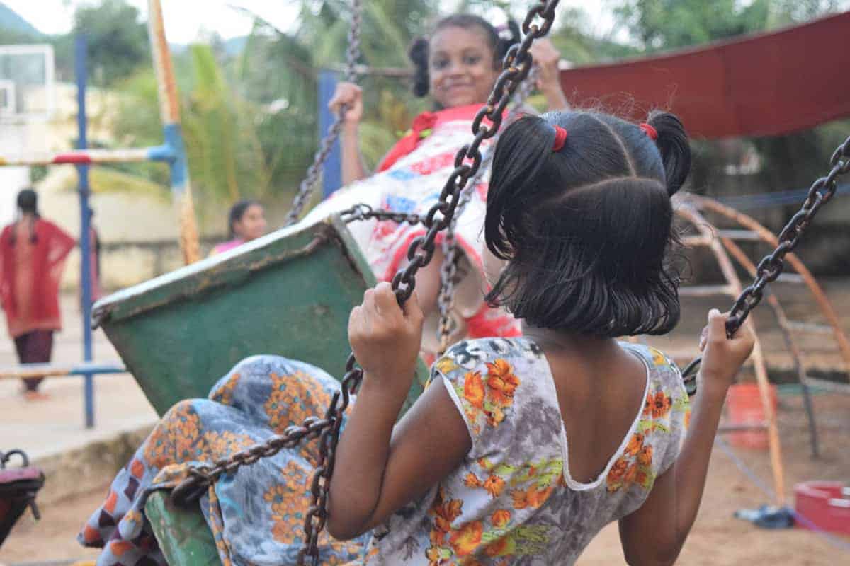 girls playing on swings