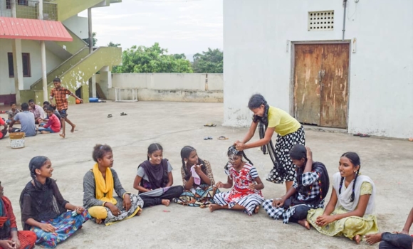 group of girls playing with watter ballons