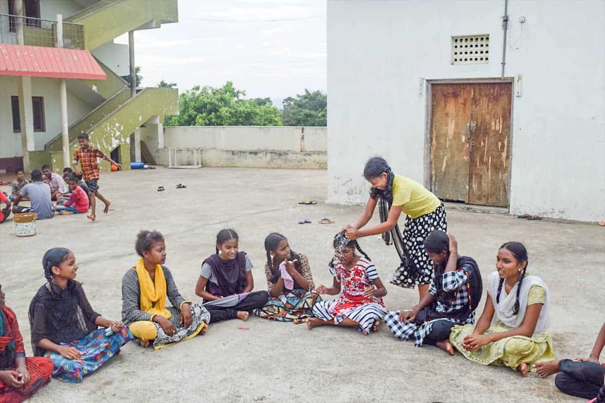 group of girls playing with watter ballons