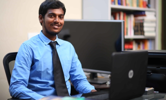 older student at computer desk