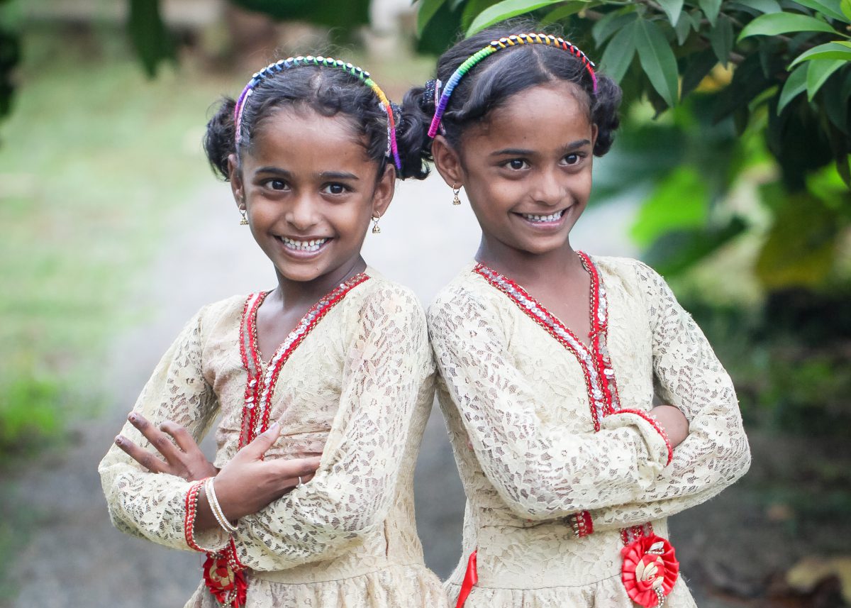 twin sisters posing together in their best dress