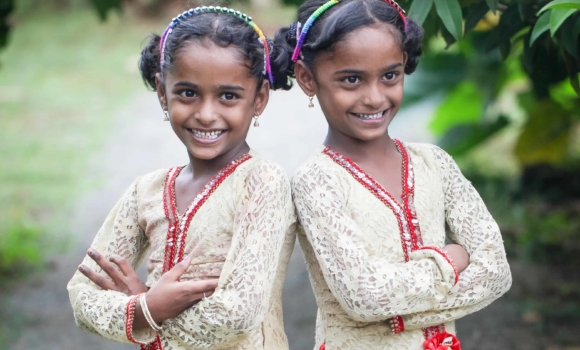 twin sisters posing together in their best dress