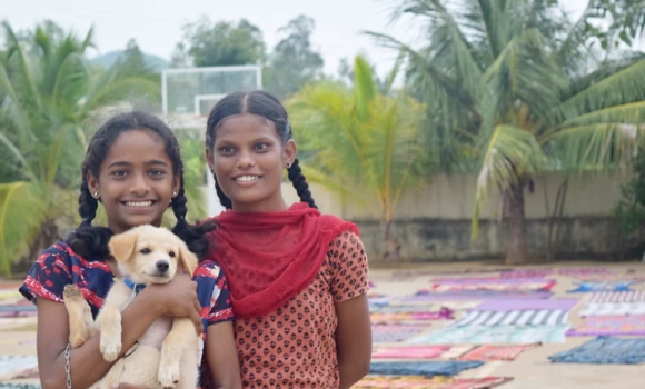 two girls with a puppy