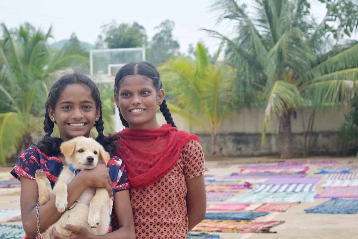 two girls with a puppy