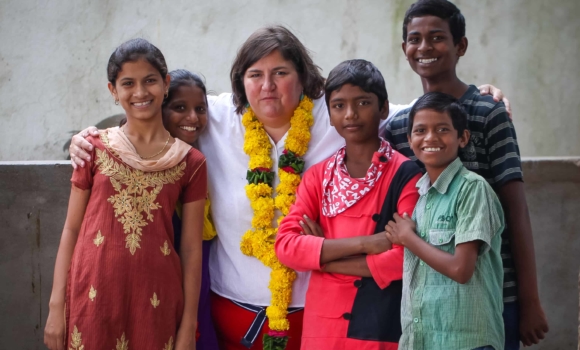 visitor to children of faith home with a group of kids