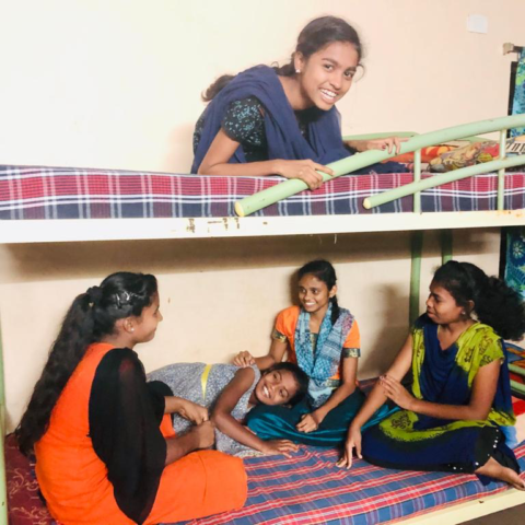 Older girls returned to the home sitting laughing in their bunk beds