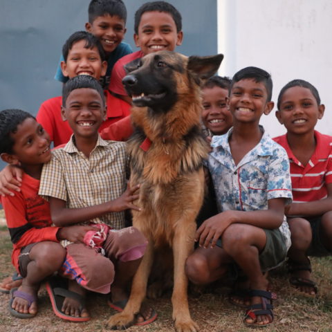 Boys surround their pet dog