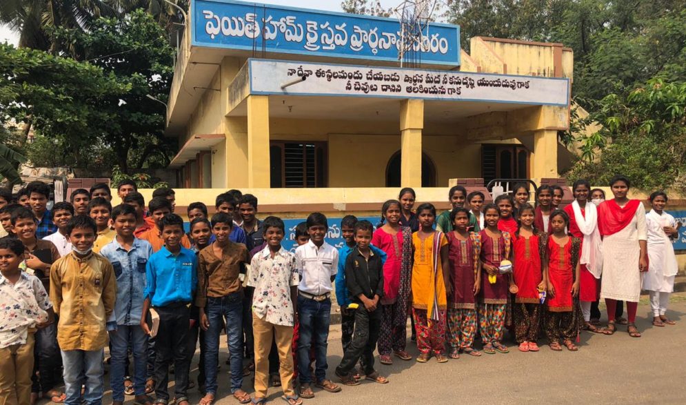 Children are dreesed for Easter and gather in front of their church