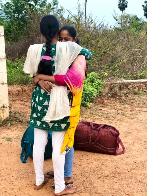 Girls hug and say good-bye in India