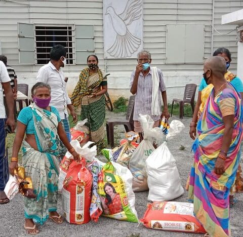 Men and women with supplies at Grocery Distribution event in India