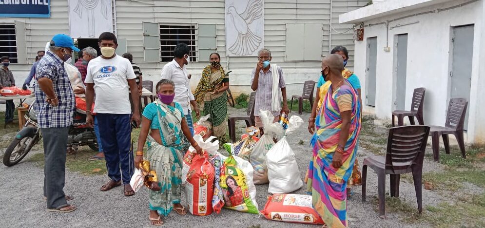 Men and women with supplies at Grocery Distribution event in India