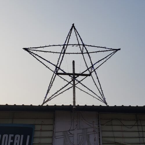 A large star made with lights on the roof of Children of Faith in India