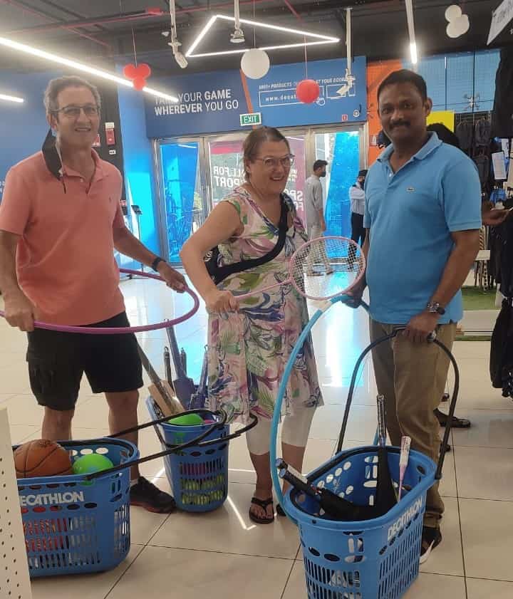 Visitors and the Home's co- founder with baskets of sports equipment  for the children in India