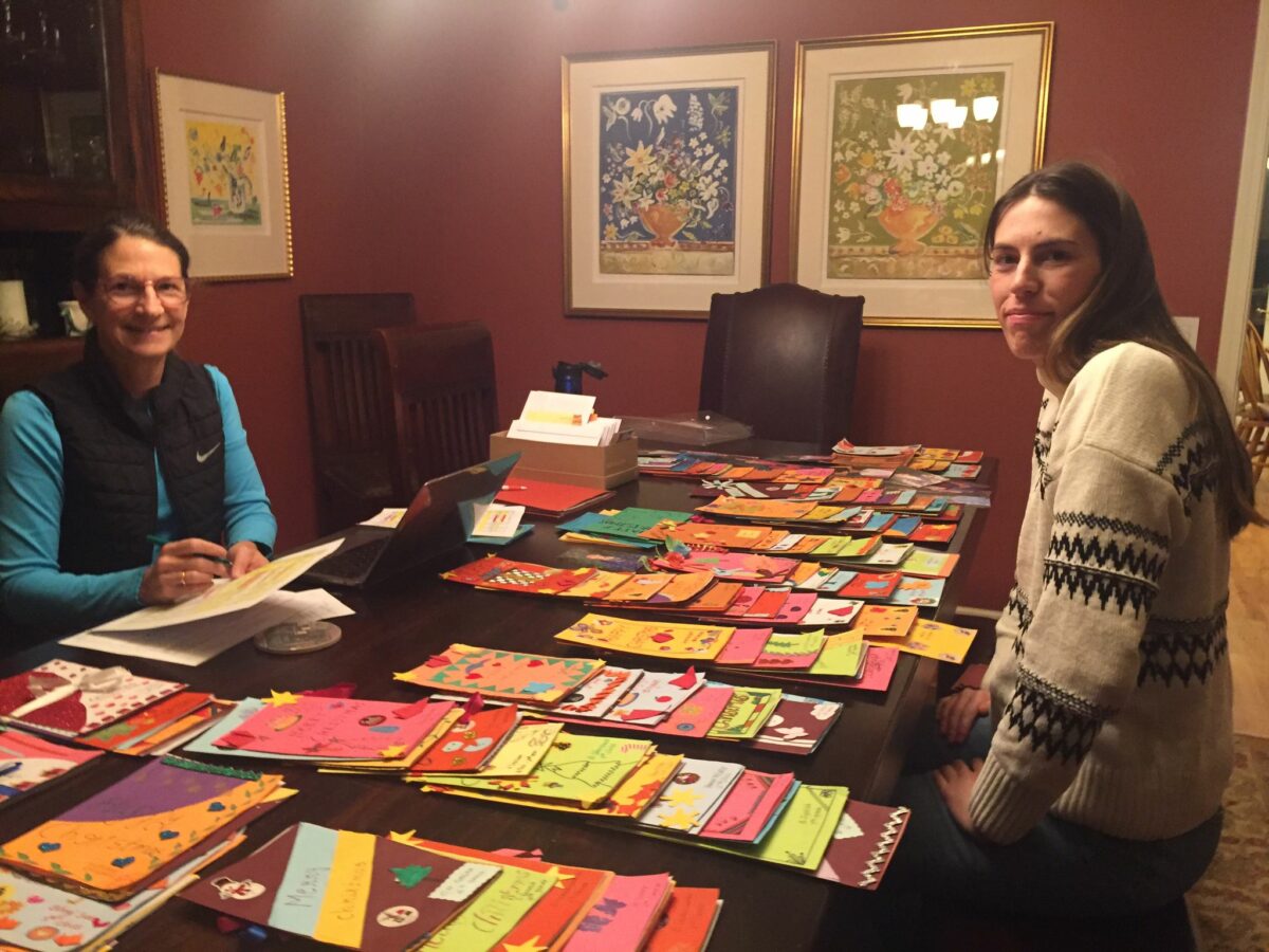 Two volunteers sort beautiful cards handmade to thank to the sponsors of children in the children of Faith Home in India.