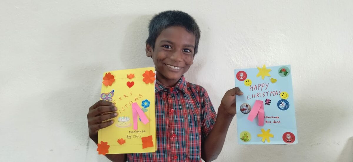 A young boy in India shows the beautiful cards he made as a thank you to her sponsor in the Children of Faith Home in India.
