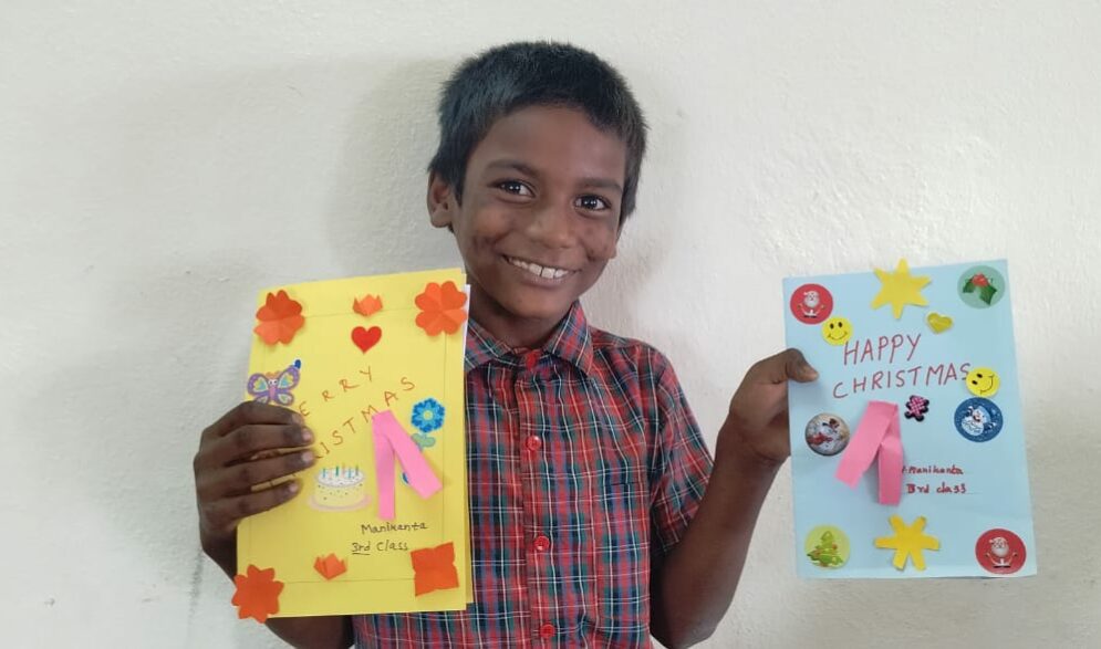 A young boy in India shows the beautiful cards he made as a thank you to her sponsor in the Children of Faith Home in India.