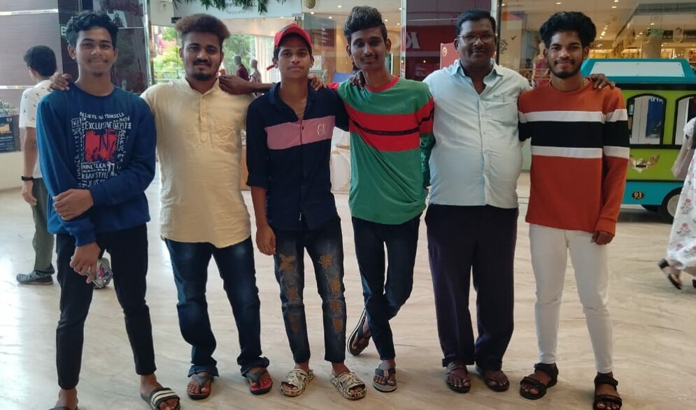 Serval boys join with a staff member at the Children of Faith Home in India