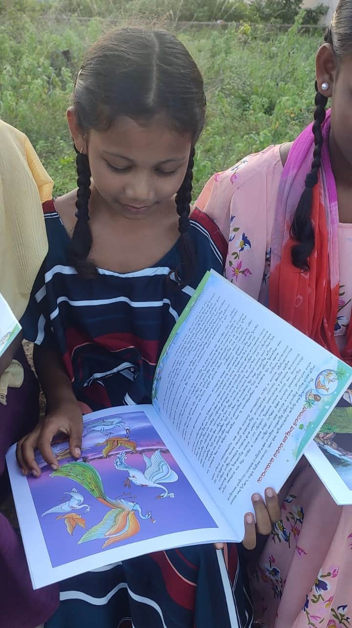 Girl reading a book at Children of Faith in India
