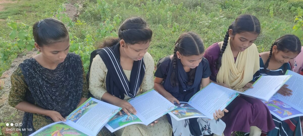 Several girls reading donated books at the Children of Faith Home in India