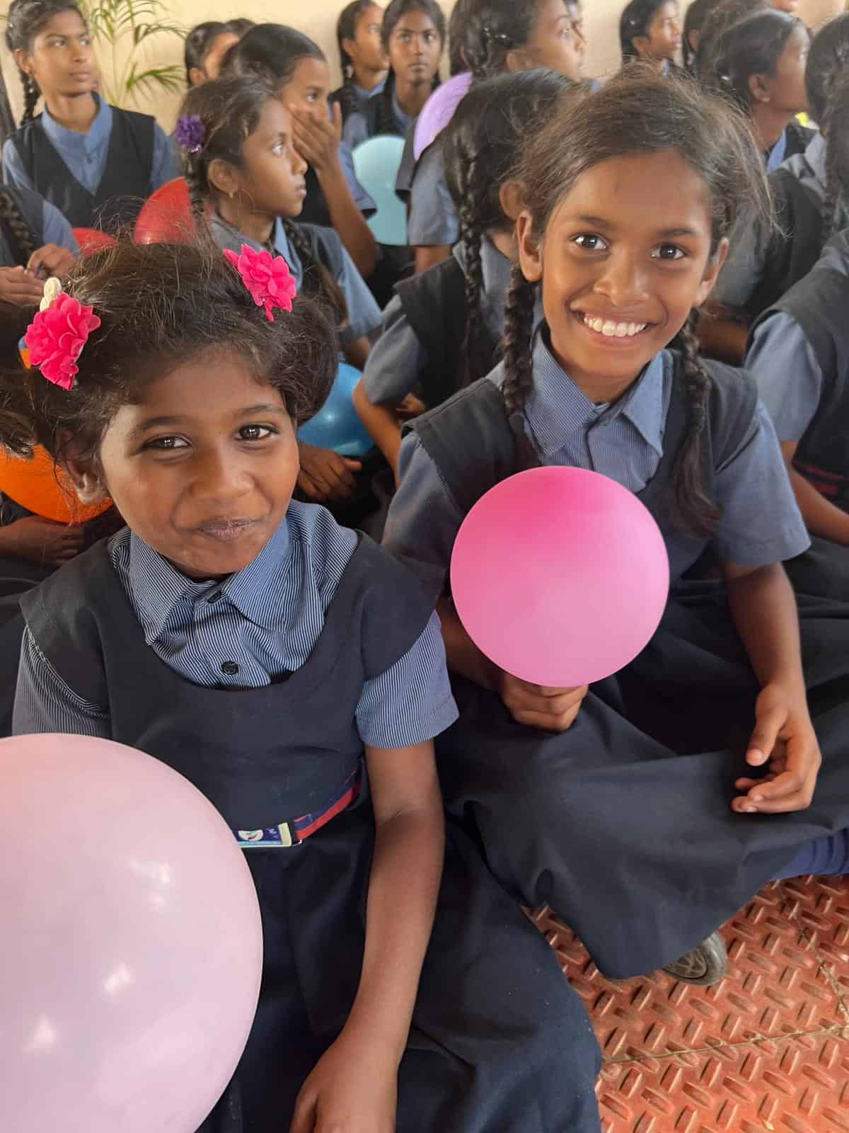 Girls with balloons at Children of Faith
