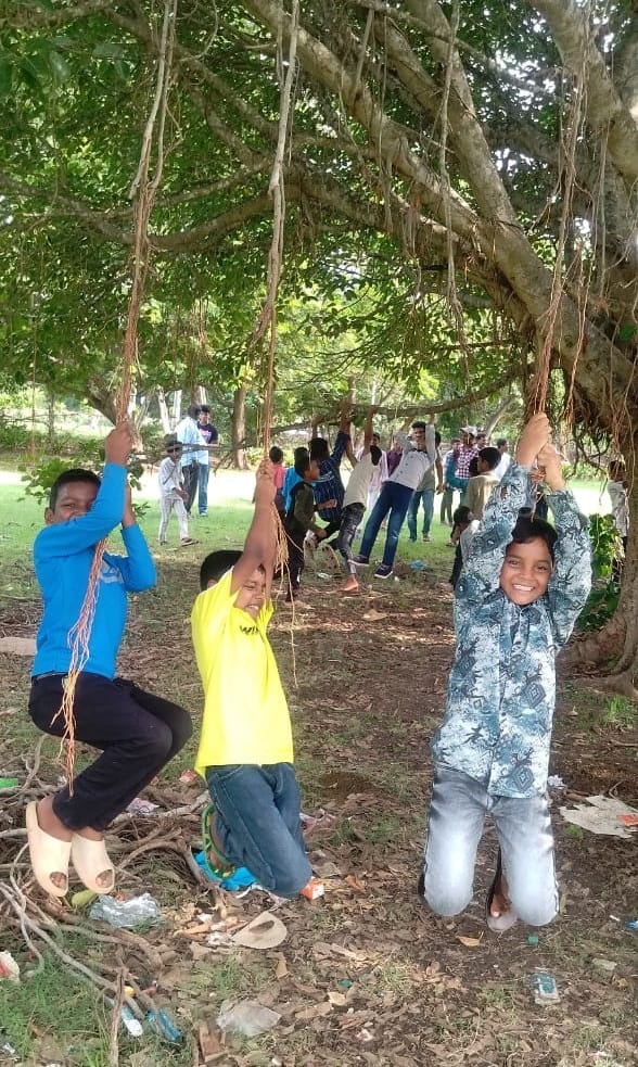 Boys from children of Faith in India enjoy swinging on ropes in the park