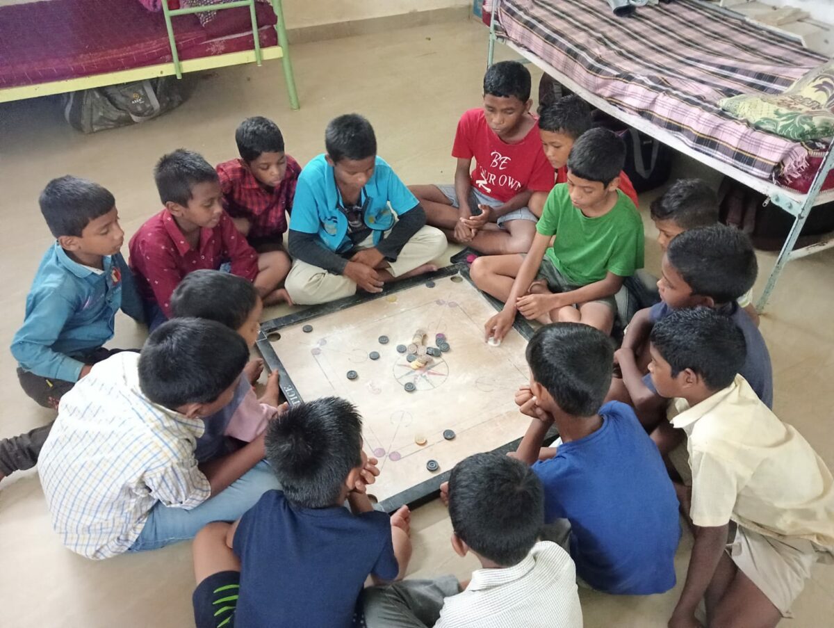 Boys play a tradtional Indian game on rainy days at Children of Faith in India