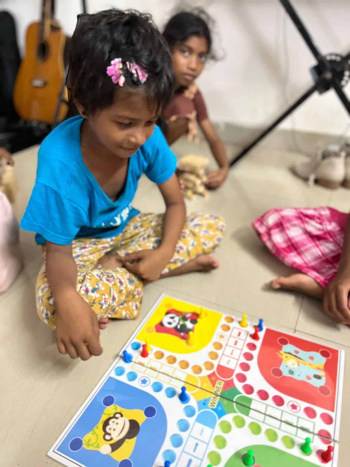 Young girl plays a game at the Children of Faith Home