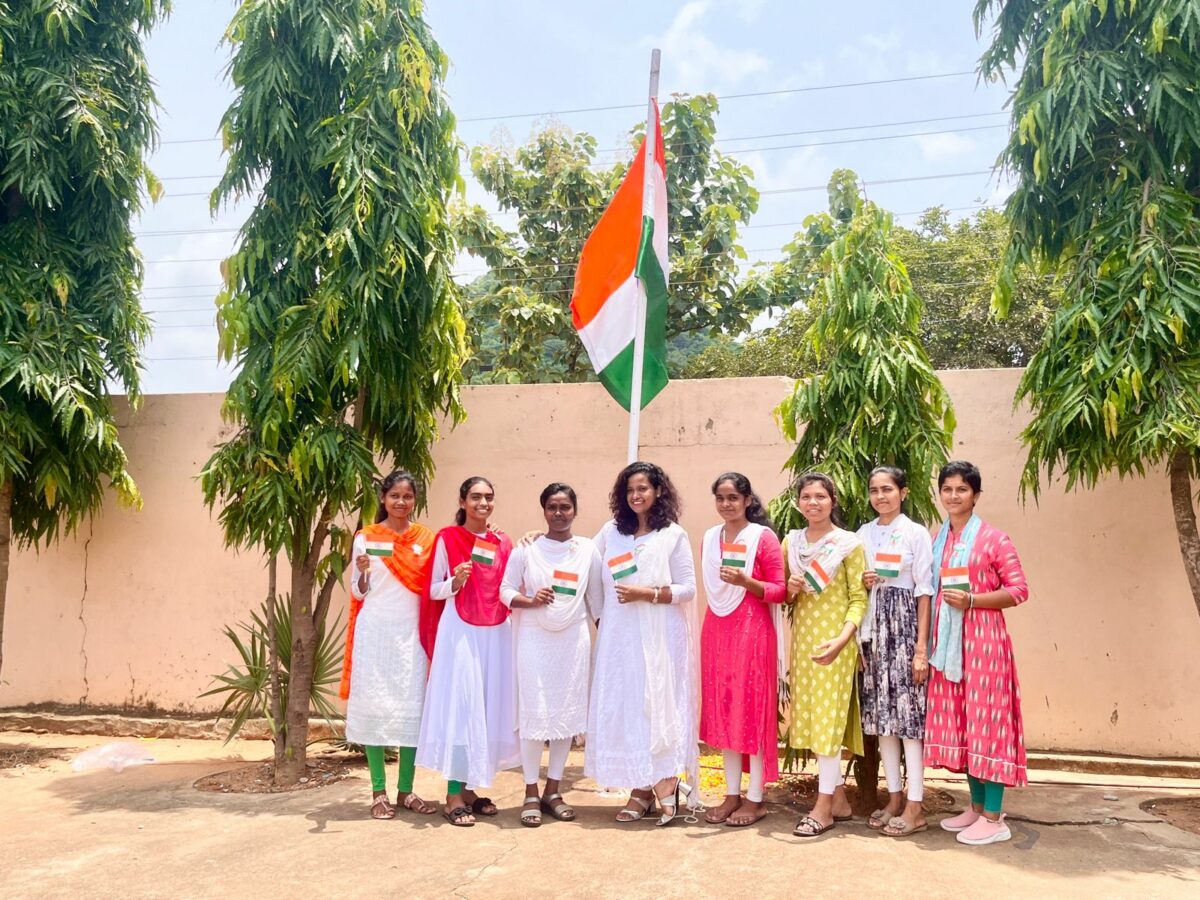 Rosie joins some older girls around the India Flag