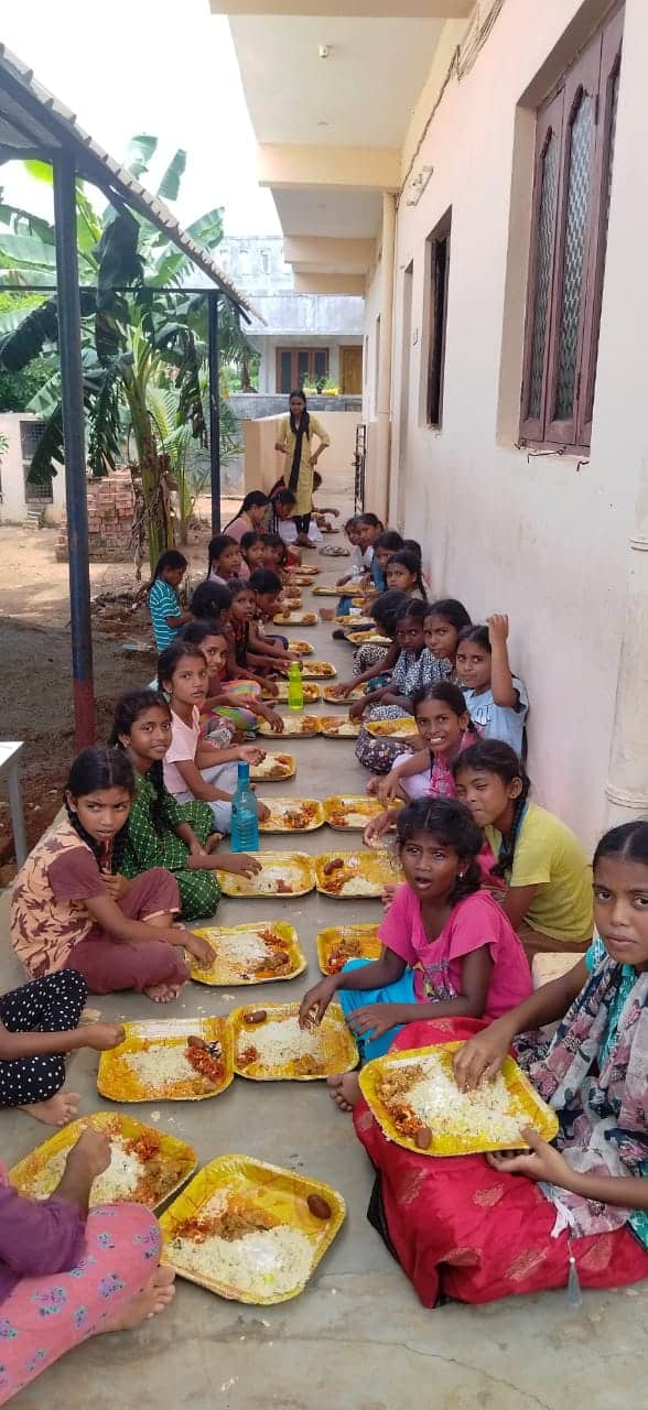 enjoying a special meal for Independence Day at Children of Faith