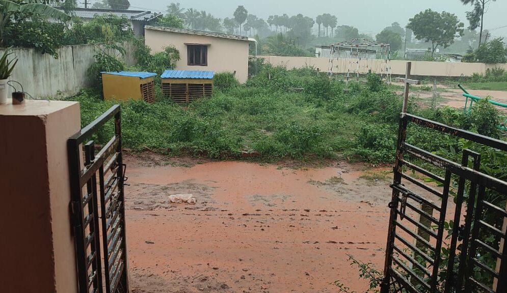 Rains pours down outside the gates to Children of Faith Home in India