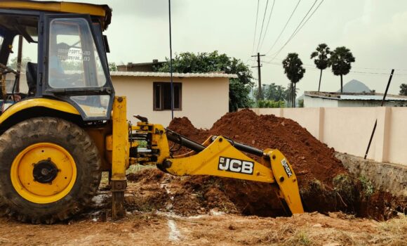 Back hoe works on modern kitchen construction at Children of Faith in India