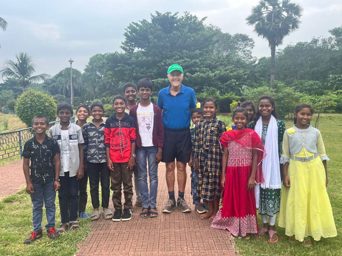 A visitor to Children of Faith in India enjoys time with the children in the parlk