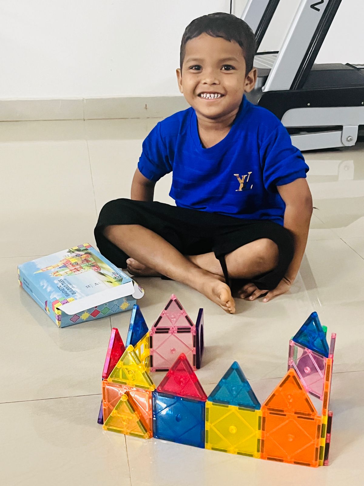 A boy plays with magnetic blocks at the Children of Faith Home in India