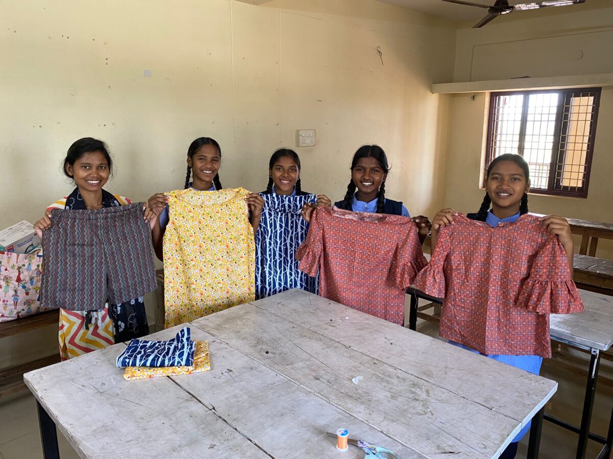 Girls show garments they have sewn at the Children of Faith Home in Visakhapatnam India