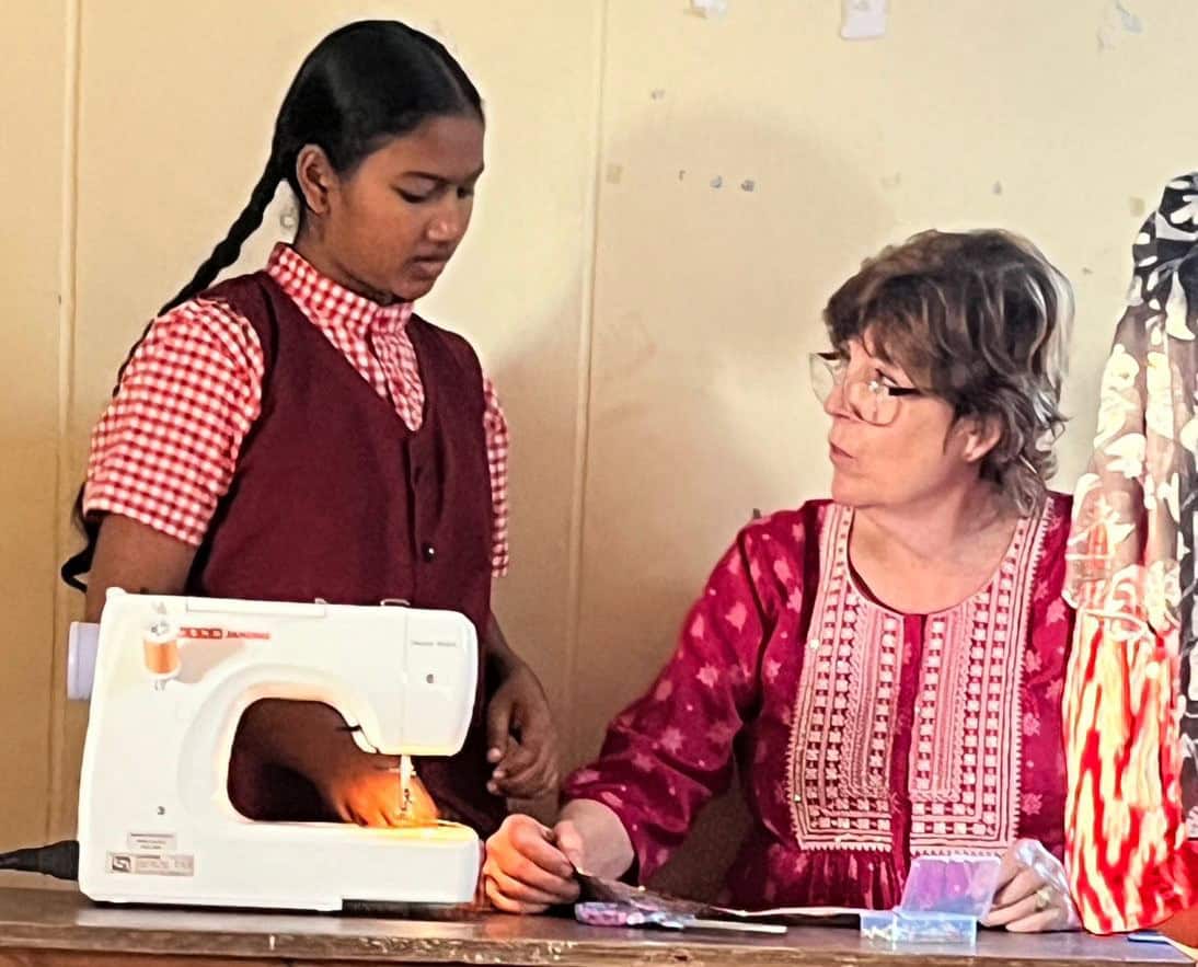 A young girl is learning to sew at the Children of Faith Home in India